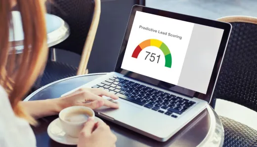 Person using a laptop displaying a predictive lead scoring dashboard with a score of 751, representing the use of machine learning for efficient sales prioritization.